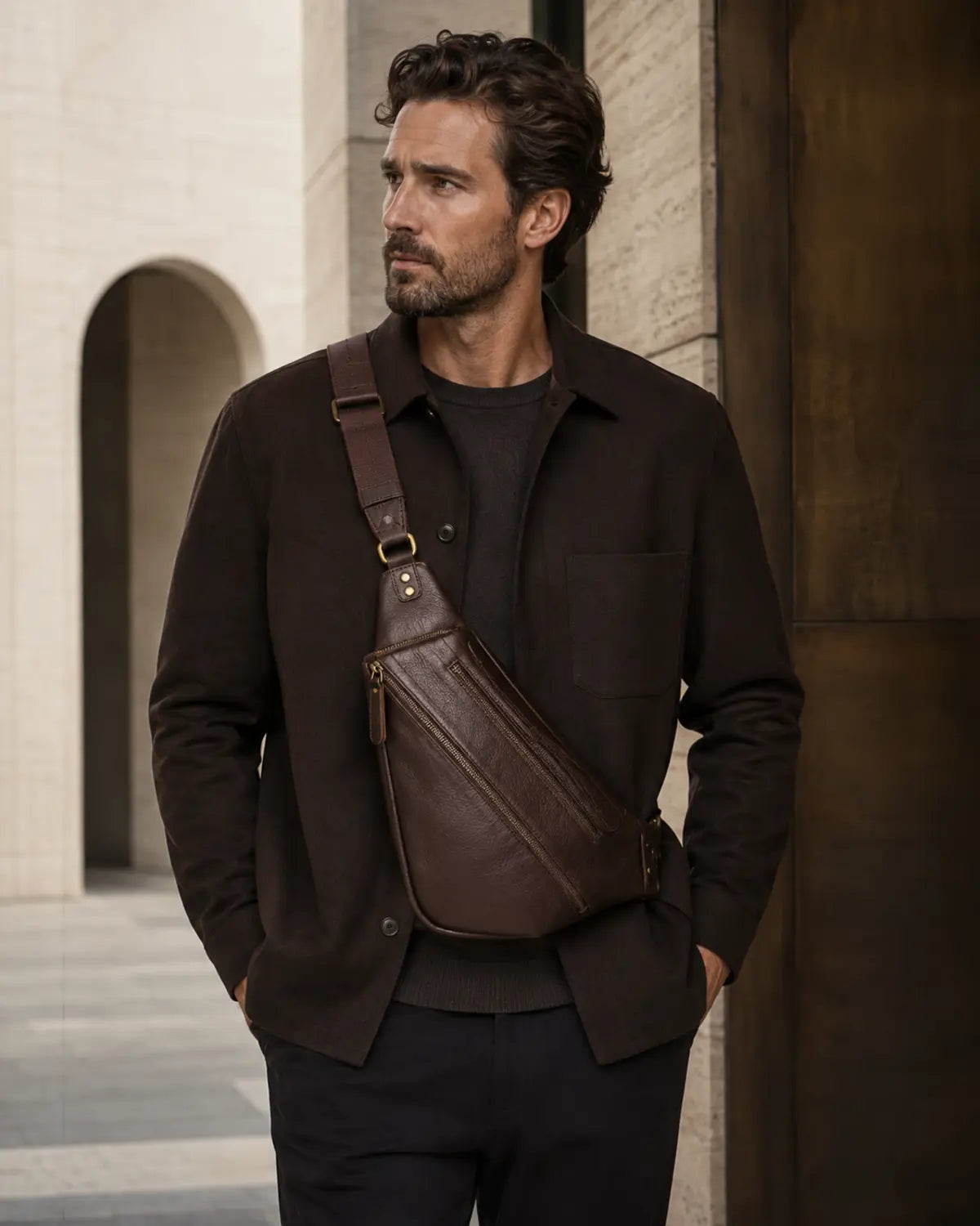 Adult model wearing the original Wolfoco Nomad dark chocolate leather sling